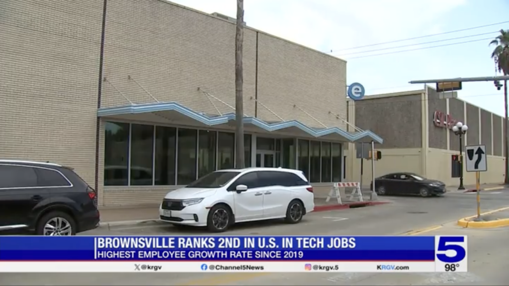 Exterior view of a building in Brownsville, Texas, with a news headline stating, "Brownsville ranks 2nd in U.S. in tech jobs, highest employee growth rate since 2019," as reported by KRGV Channel 5 News.